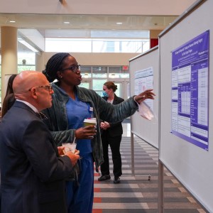 Dr. Kristina Warner shares poster at department research event