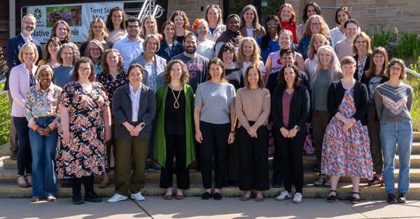 Many members of the Division of Academic Specialists in Ob-Gyn stand together on a staircase outside the UW-Madison Arboretum visitor center.