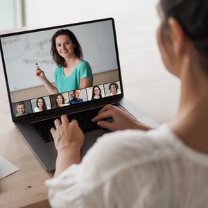 Person sitting at laptop participating in webinar